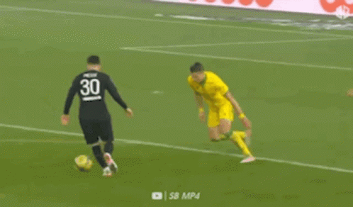 A Soccer Player In A Yellow Jersey Is Kicking A Soccer Ball On A Soccer Field . GIF