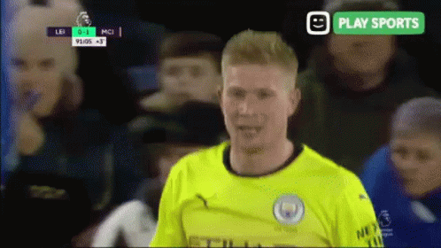 A Soccer Player In A Yellow Jersey Stands In Front Of A Play Sports Banner GIF