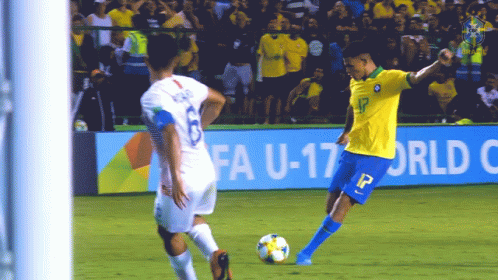 a soccer player in a yellow jersey with the number 13 on it