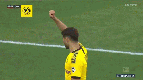 a soccer player in a yellow jersey with the number 5 on the back