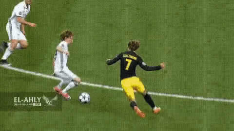 A Soccer Player In A Yellow Jersey With The Number 7 On It Is Kicking A Soccer Ball On A Soccer Field . GIF