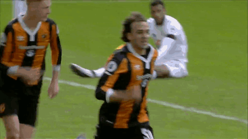 A Soccer Player In An Orange And Black Jersey With The Number 3 On The Front GIF