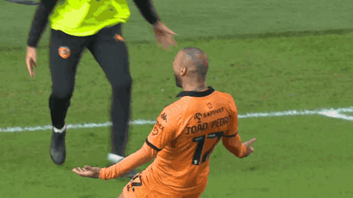 A Soccer Player In An Orange Jersey With The Number 7 On The Back GIF