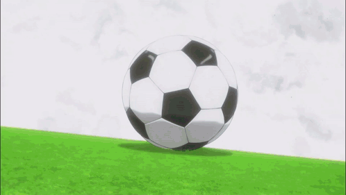 a soccer player in red shorts is kicking a soccer ball