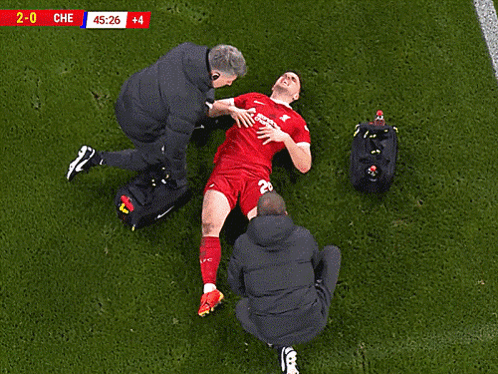 A Soccer Player Is Being Helped On The Field With The Score 2-0 Che GIF