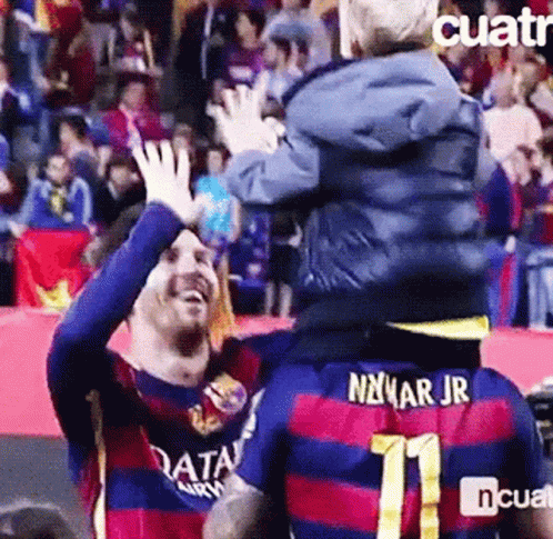 A Soccer Player Is Carrying A Child On His Shoulders And The Child Is Wearing A Number 11 Jersey . GIF