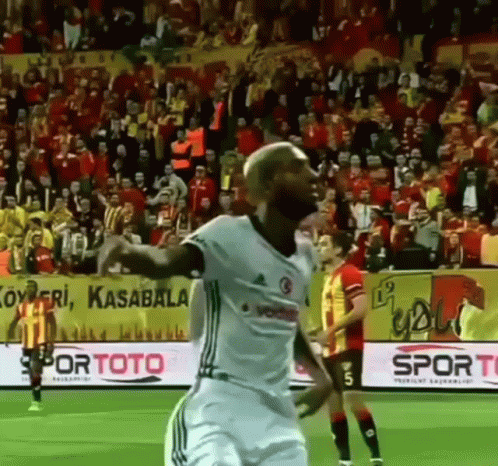 A Soccer Player Is Celebrating A Goal During A Game GIF