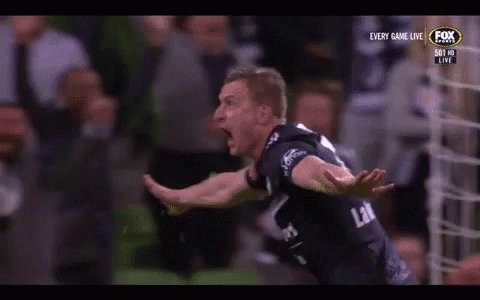 A Soccer Player Is Celebrating A Goal In Front Of A Crowd On A Television Screen . GIF