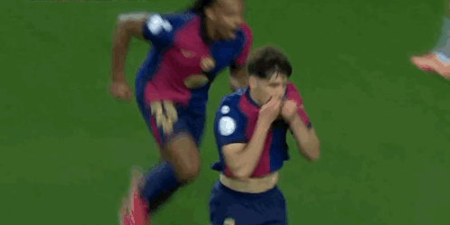 A Soccer Player Is Celebrating A Goal On The Field While Another Player Watches . GIF
