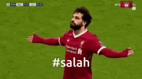 A Soccer Player Is Celebrating A Goal With A # Salah Hashtag . GIF