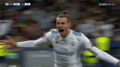 A Soccer Player Is Celebrating A Goal With His Arms Outstretched In Front Of A Crowd . GIF