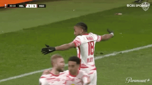 A Soccer Player Is Celebrating A Goal With His Teammates On A Soccer Field . GIF