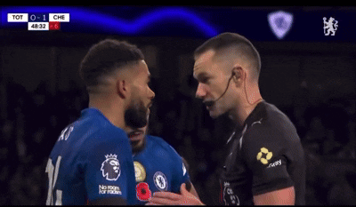 A Soccer Player Is Covering His Mouth With His Hand During A Game Between Tot And Che GIF