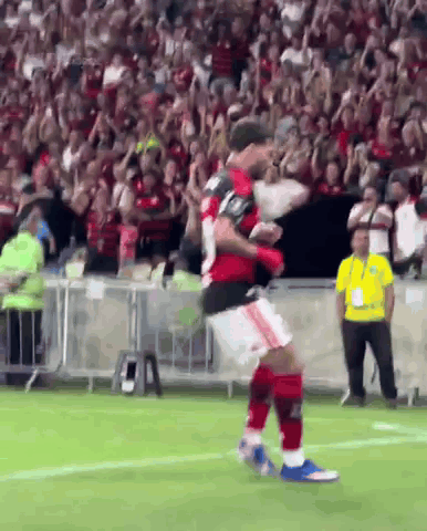 a soccer player is jumping in the air on a field