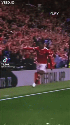 A Soccer Player Is Jumping In The Air On A Field . GIF