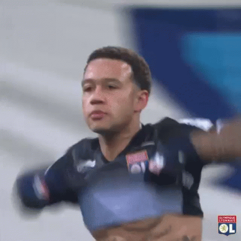 a soccer player is jumping in the air with his arms outstretched in a gif .