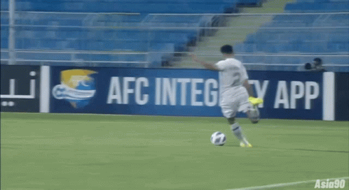 A Soccer Player Is Kicking A Ball In Front Of An Afc Integrity App Sign GIF