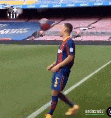 A Soccer Player Is Kicking A Ball On A Field GIF