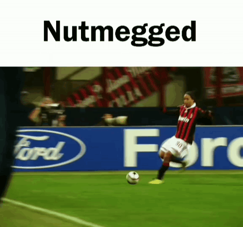 A Soccer Player Is Kicking A Soccer Ball In Front Of A Ford Banner GIF