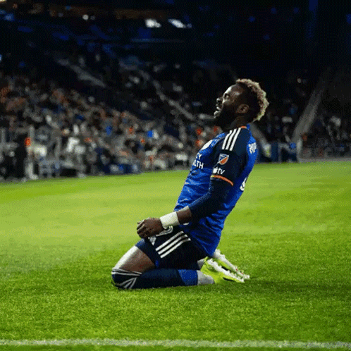 A Soccer Player Is Kneeling On The Field And His Jersey Says Mtv On The Sleeve GIF