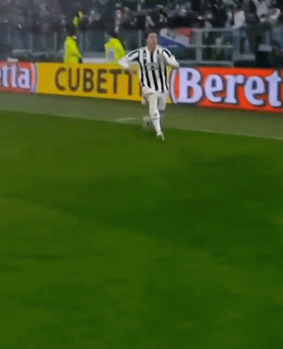 A Soccer Player Is Kneeling On The Field In Front Of A Beretta Banner GIF