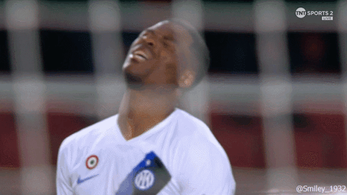 A Soccer Player Is Laughing While Wearing A White Shirt That Says Nike On It GIF
