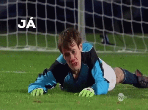 A Soccer Player Is Laying On The Field With Blood On His Face And The Word Ja Above Him GIF