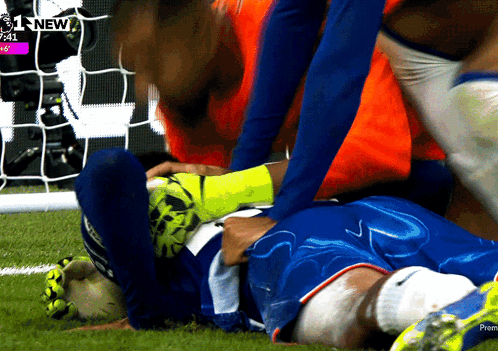 A Soccer Player Is Laying On The Field With The Time 7:41 On The Screen Behind Him GIF