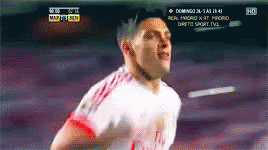 a soccer player is running in front of a tv screen that says domingo on it