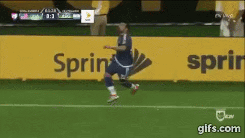 A Soccer Player Is Running On A Field In Front Of A Sprint Sign GIF