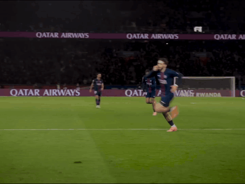 A Soccer Player Is Running On A Field With Qatar Airways Advertisements In The Background GIF