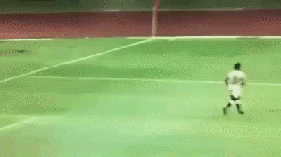 A Soccer Player Is Running On A Green Field GIF