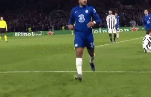A Soccer Player Is Running On A Soccer Field With A Ball In His Hand . GIF