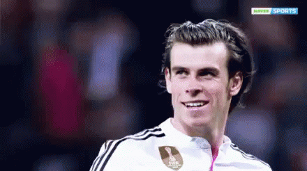 A Soccer Player Is Smiling In Front Of A Hopper Sports Logo GIF