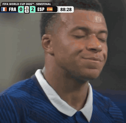 a soccer player is smiling in front of a screen that says fifa world cup