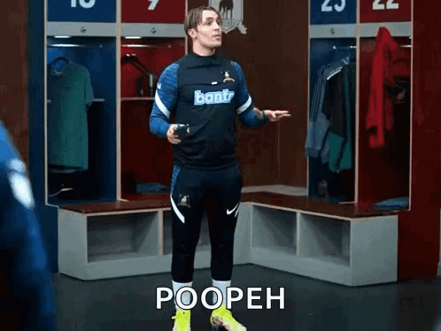 A Soccer Player Is Standing In A Locker Room With The Words Poopeh Written On The Floor . GIF