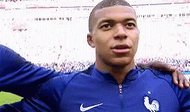 A Soccer Player Is Standing On A Field With His Arm Around Another Player . GIF