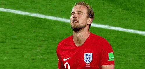 A Soccer Player Is Standing On A Field With His Eyes Closed And His Mouth Open . GIF
