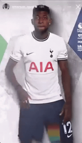 A Soccer Player Is Wearing A White Aia Jersey And Blue Shorts . GIF