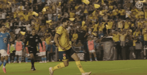 A Soccer Player Kicking A Ball In Front Of A Crowd With A Powerade Sign In The Background GIF