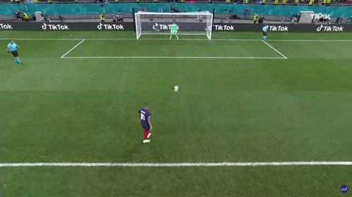 A Soccer Player Kicking A Ball In Front Of A Goal With Tik Tok Advertisements GIF