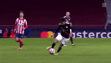A Soccer Player Kicking A Soccer Ball On A Field With A Mastercard Sign In The Background GIF