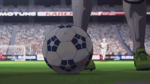 a soccer player kicks a soccer ball on a field with a motune sign in the background