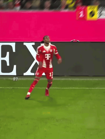 A Soccer Player Kicks The Ball In Front Of A T-Mobile Banner GIF