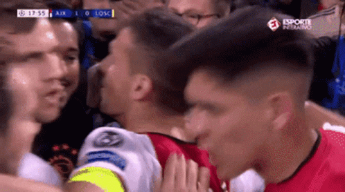 A Soccer Player Kisses Another Player On The Cheek During A Game Sponsored By Esporte Inferno GIF