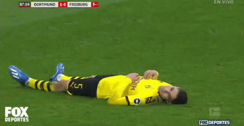 a soccer player laying on the field with the fox deportes logo