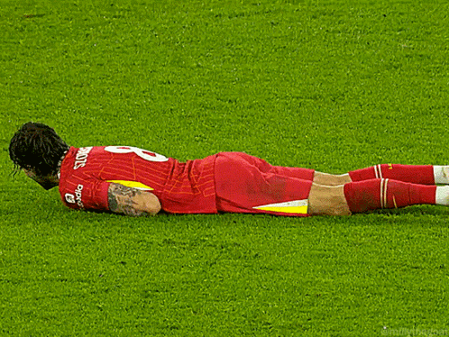 A Soccer Player Laying On The Field With The Number 8 On His Jersey GIF