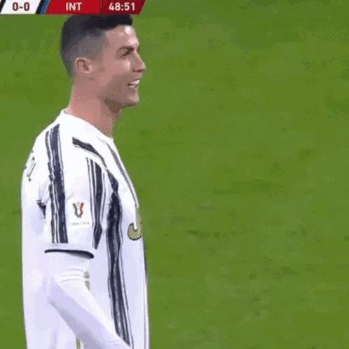 A Soccer Player Named Cristiano Ronaldo Is Laughing On The Field GIF