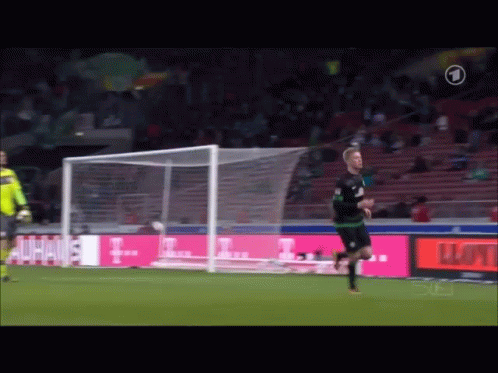 A Soccer Player Runs Towards A Goal With A T-Mobile Ad In The Background GIF