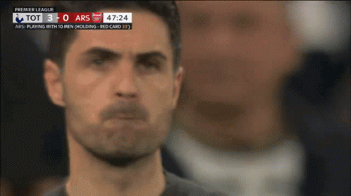 A Soccer Player Stands In Front Of A Scoreboard That Says Premier League On It GIF